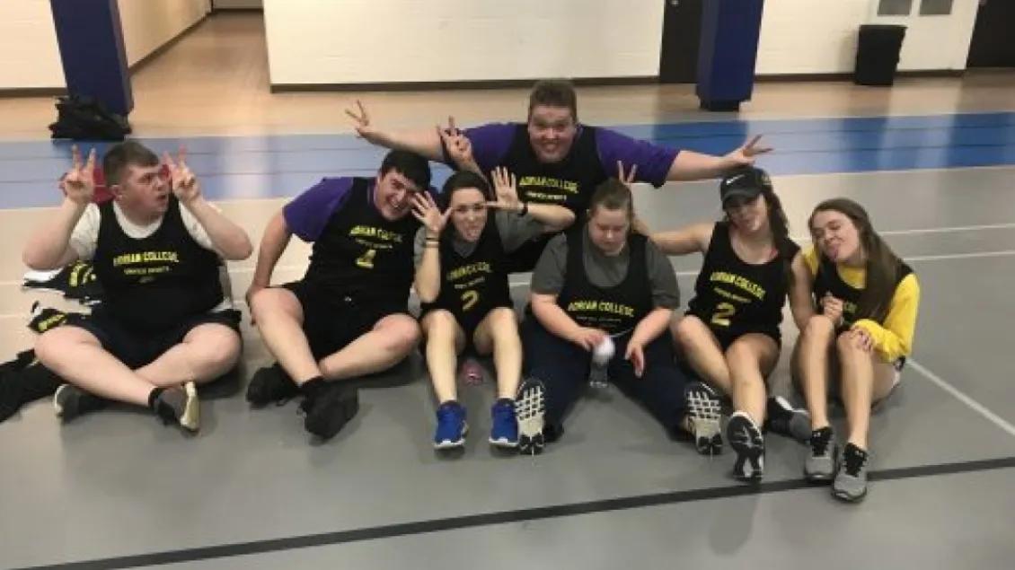 Group of people in athletic wear sitting on the ground