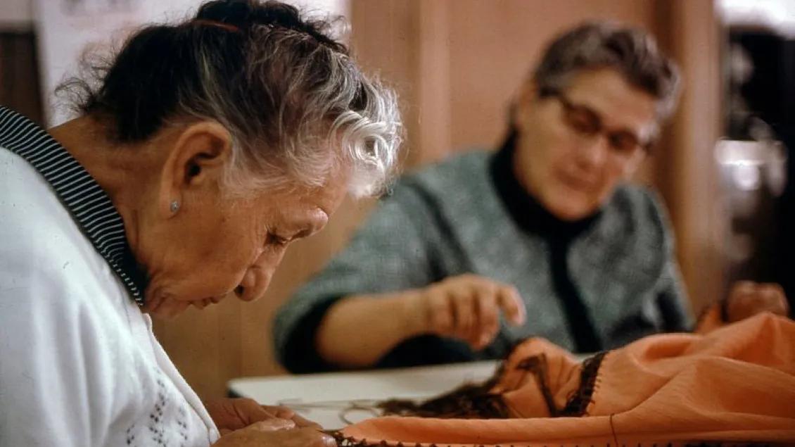 Seniors sewing at a table