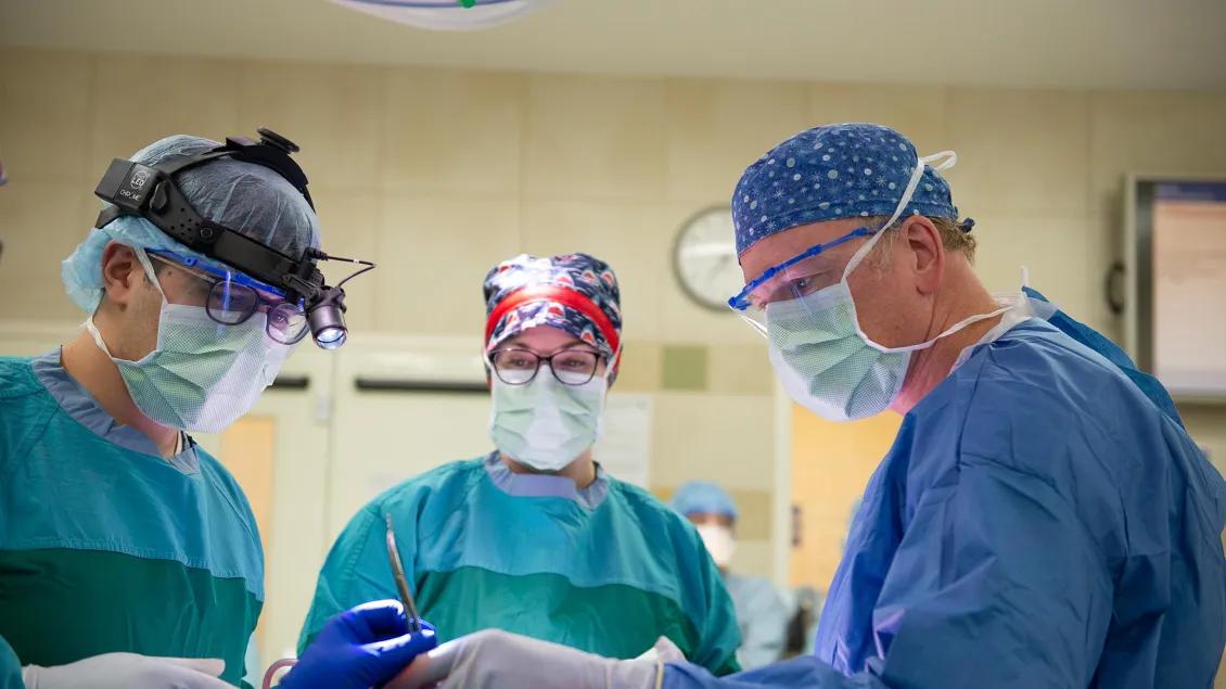 omfs assistant handing tools to surgeon