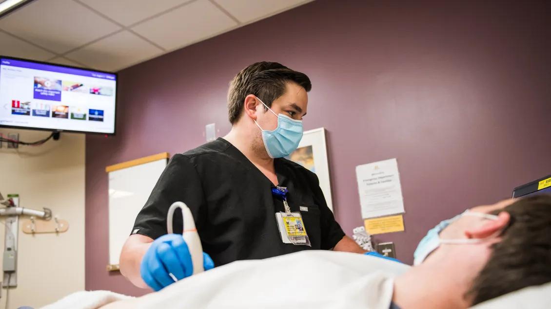 doctor performing an ultrasound on a patient