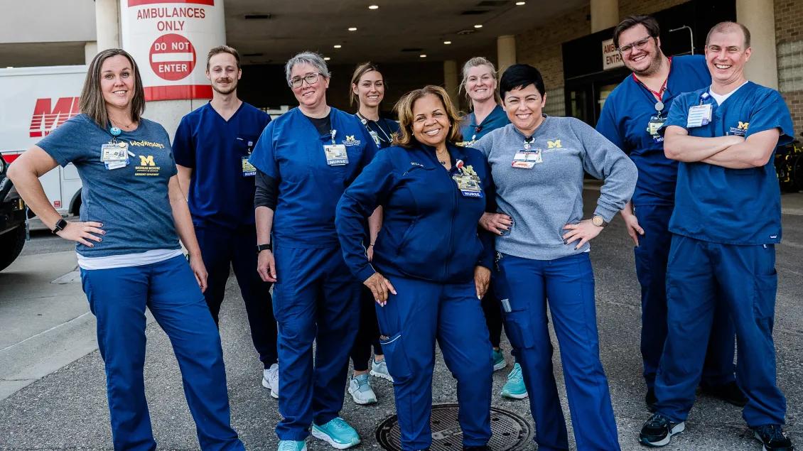 Group photo of nurses in front of hospital 
