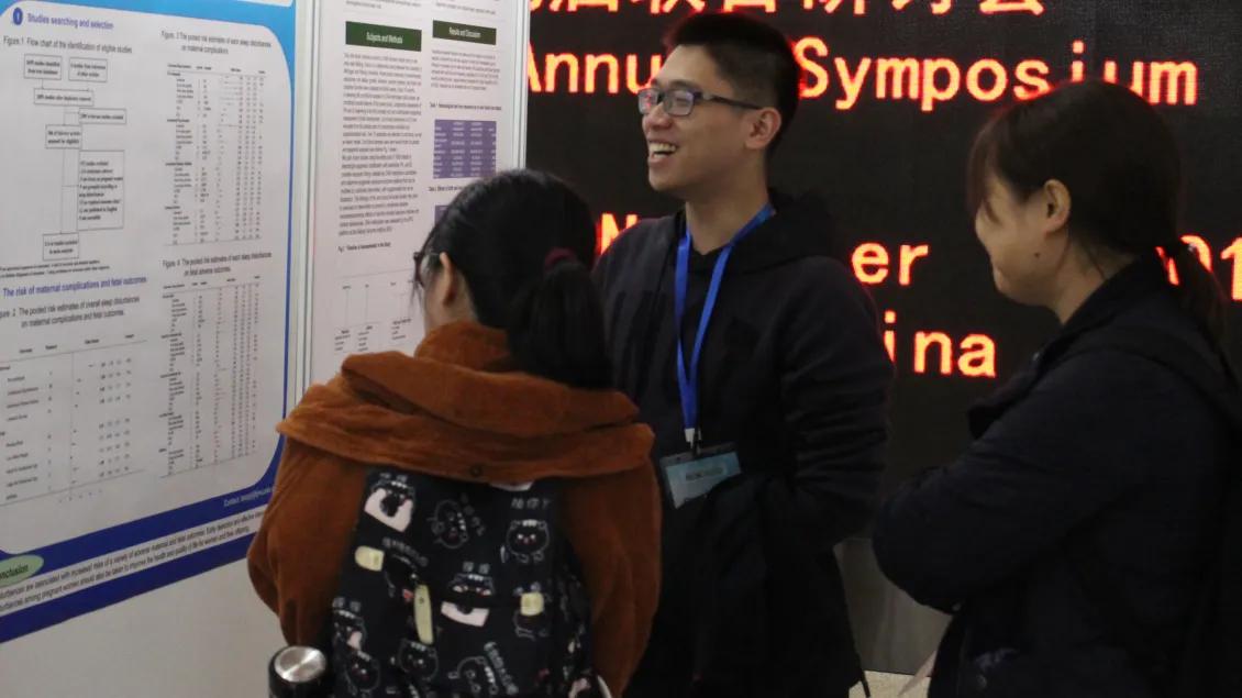 people gathering to look at poster presentations