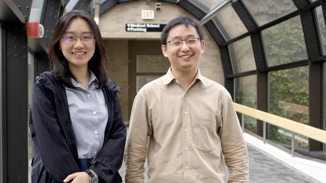man and woman posing for the camera and smiling
