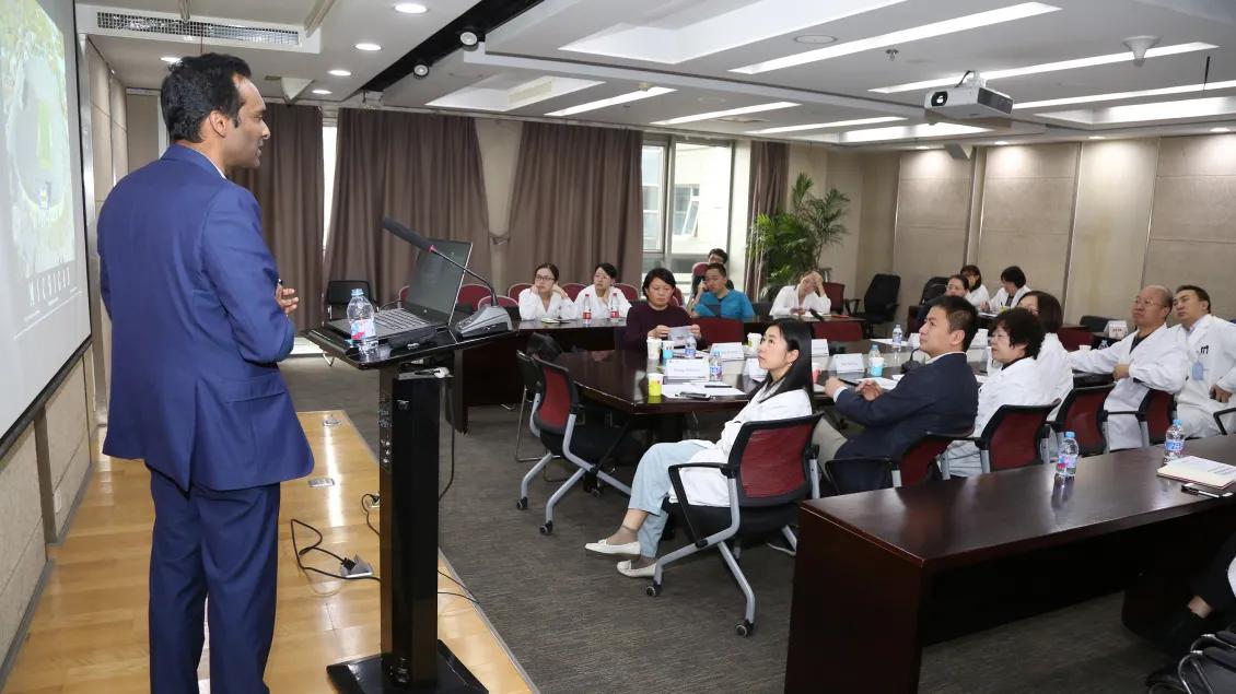man presenting to a room of people