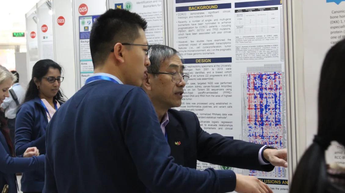 people gathering to look at poster presentations