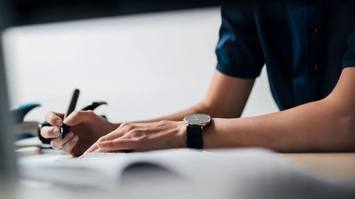 Hand writing at desk