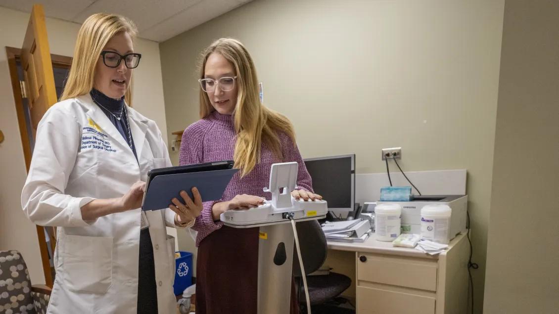 Dr. Pilewskie discussing information with someone in the clinic