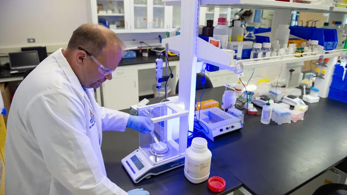 Lab member working with equipment in the lab