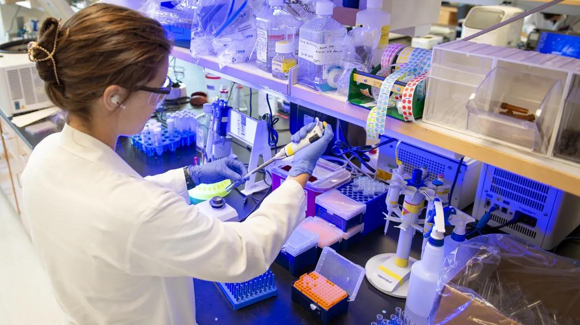 Lab member working with equipment in the lab