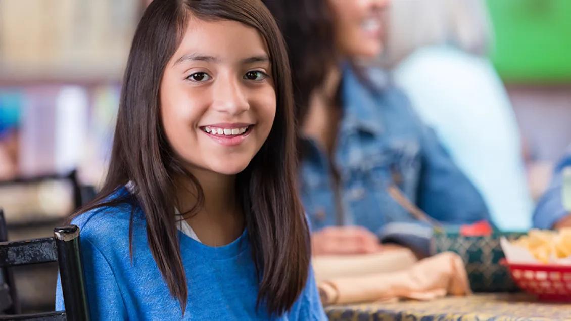 Young girl in cafeteria setting 