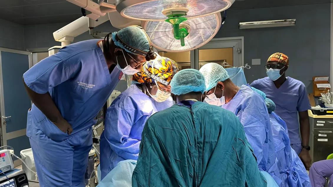 Dr. Kwakye operating with Dr. Dally and Dr. Agbedinu at Komfo Anokye Teaching Hospital.