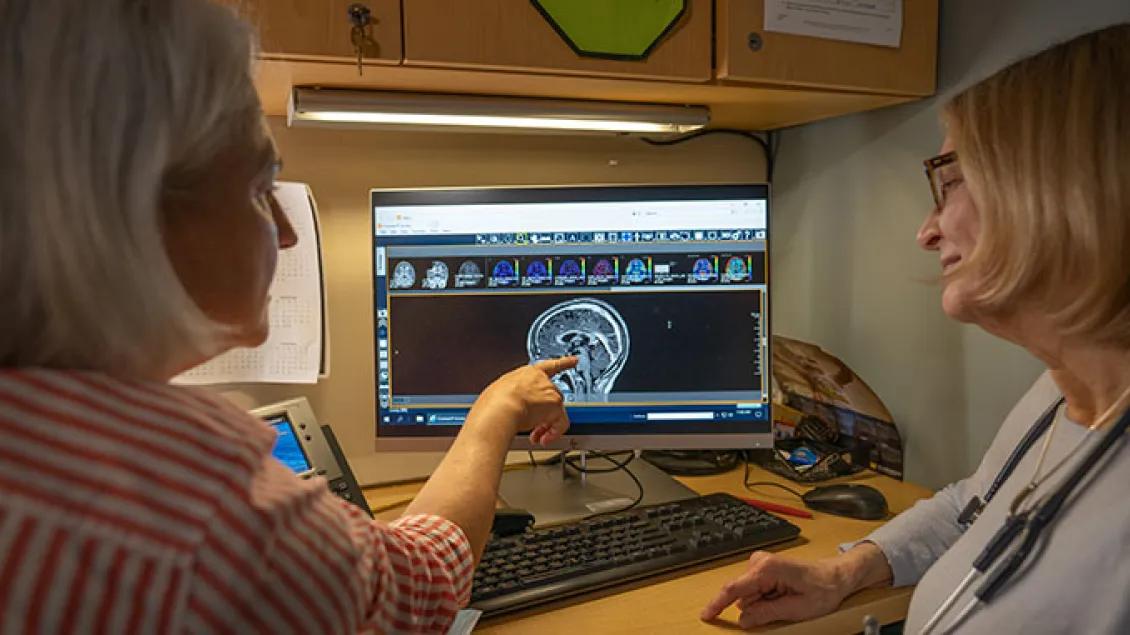 Doctors looking at medical imaging of a brain