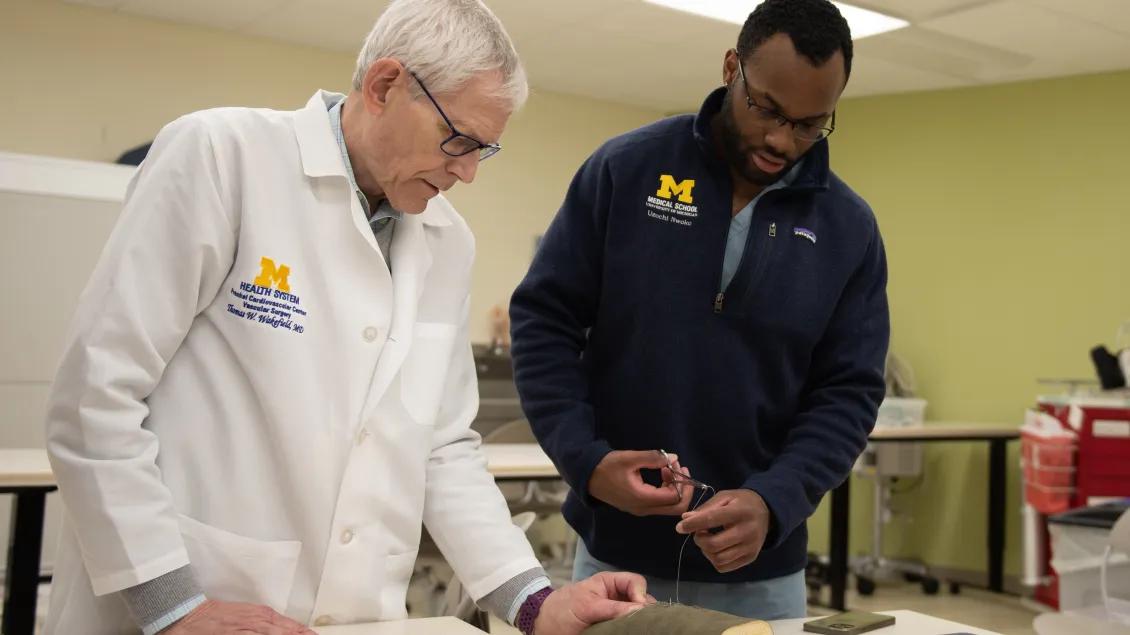 Dr. Wakefield and Uzochi Nwoko practicing a surgical skill in the Clinical Simulation Center