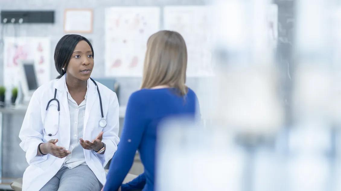 doctor talking to patient in lab