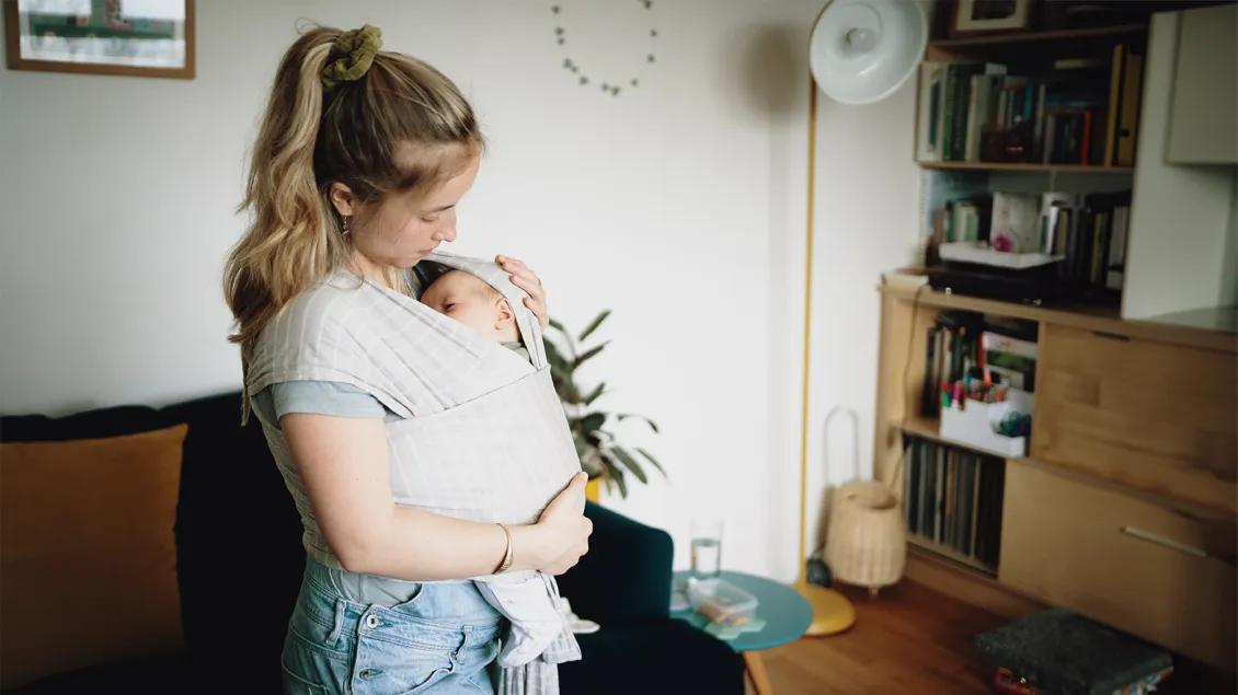 woman holding baby in living room