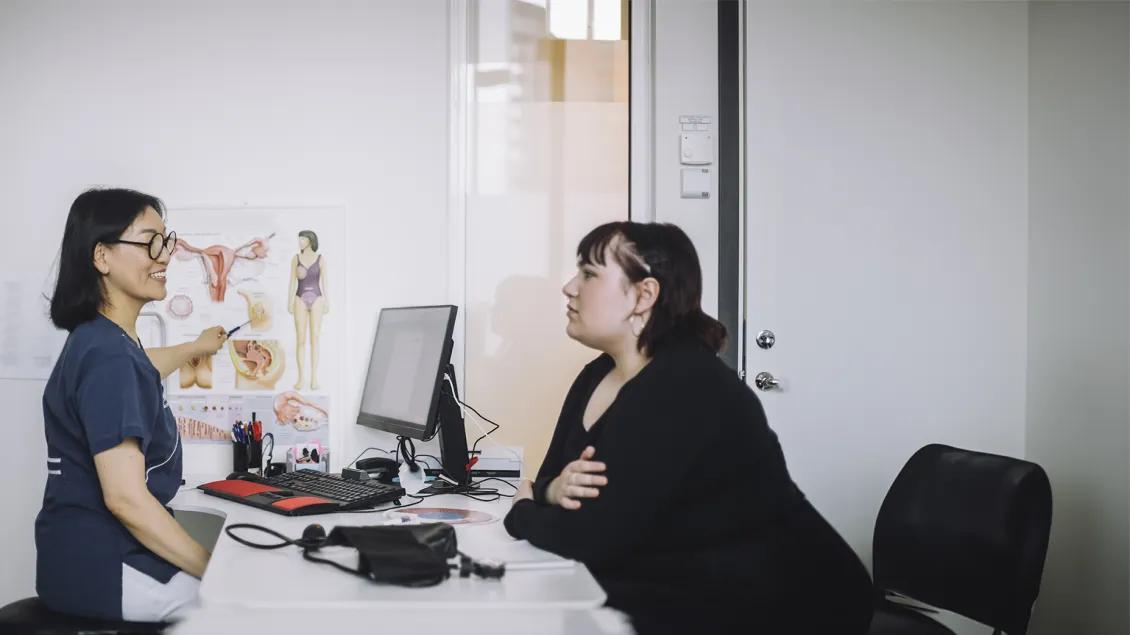 nurse speaking with patient in office