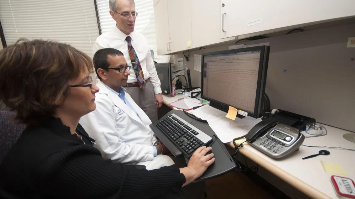 three researchers in a computer lab
