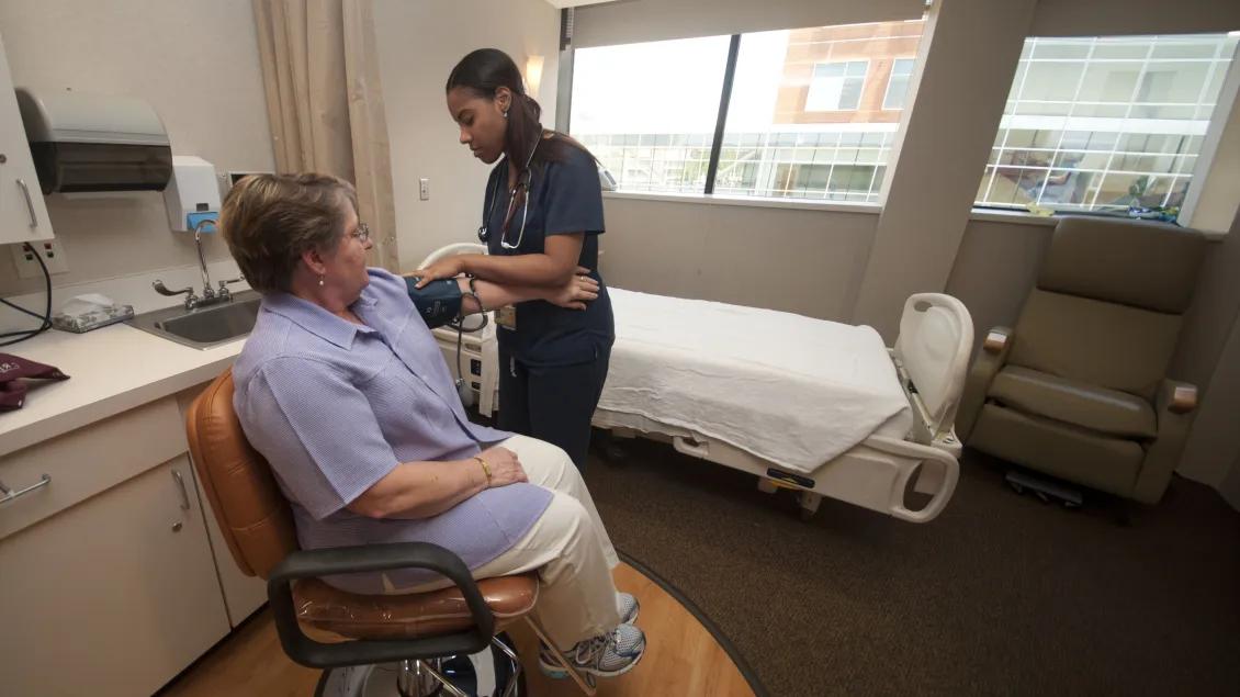 nurse and patient in hospital room