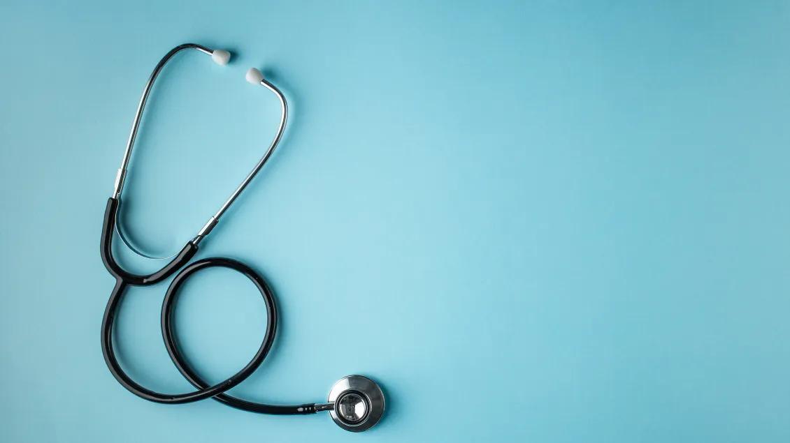 stethoscope on teal background