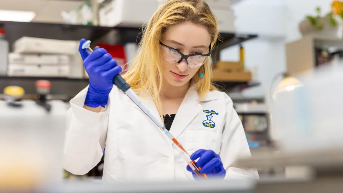 young researcher using a pipette