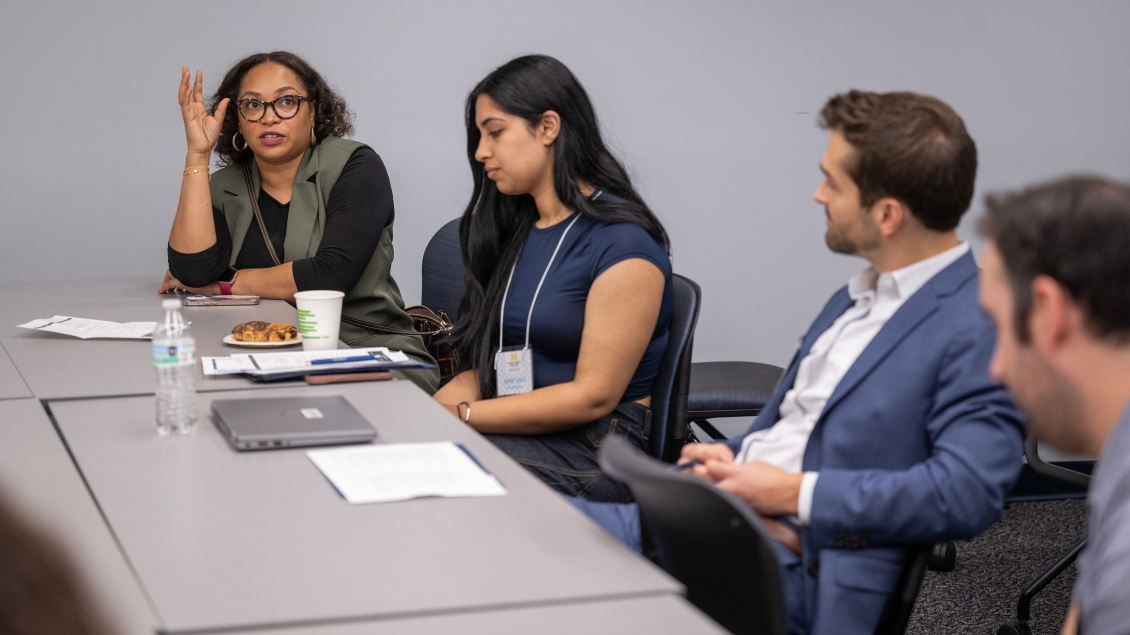 People sitting at a table and talking in a classroom
