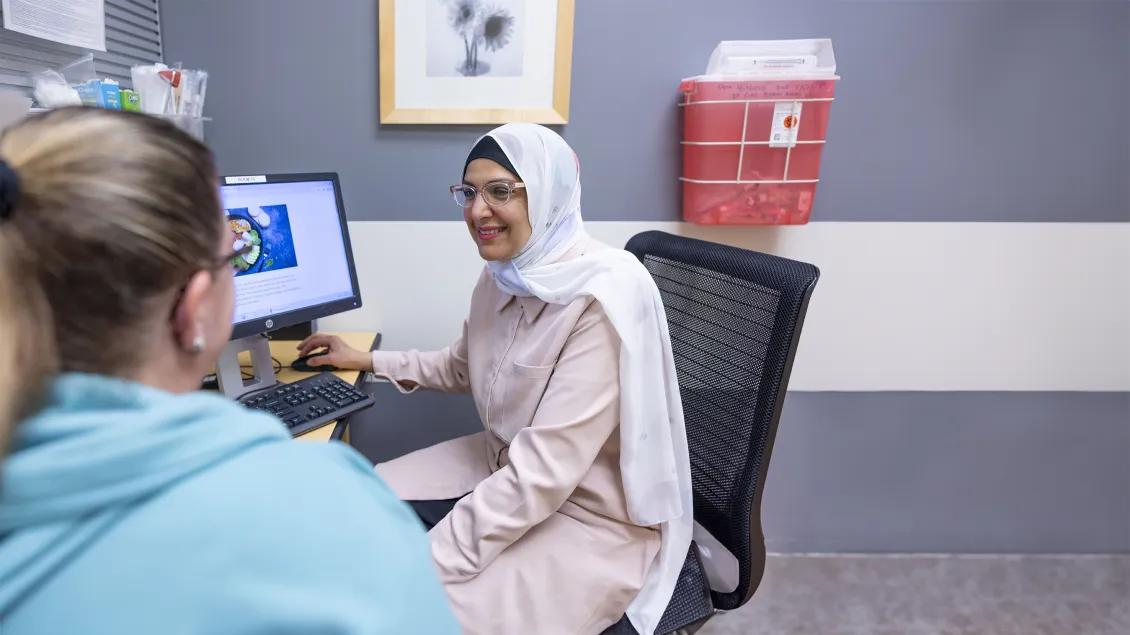 doctor speaking with patient in office