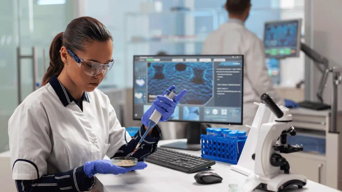Person Pipetting into Petri dish