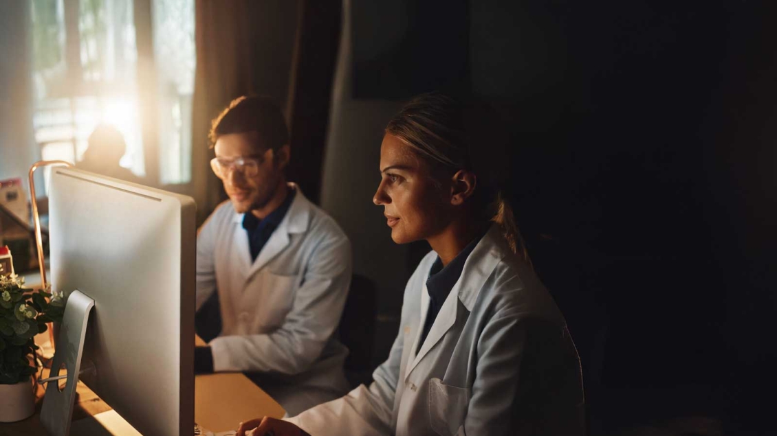 Two Researchers Watching Educational Videos on Computer