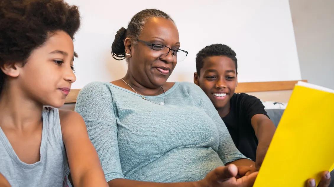 a grandmother reading with grandkids 