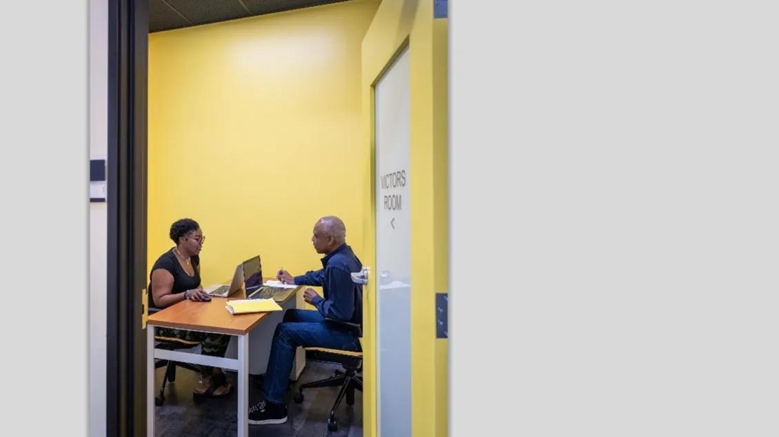 two people sitting across from each other at a table
