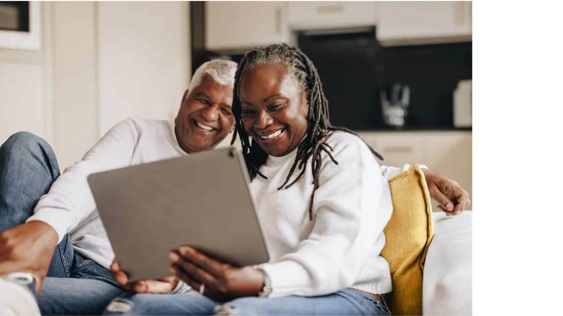 a couple smiling at ipad