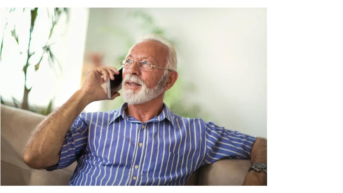 an older man sitting on a couch 
