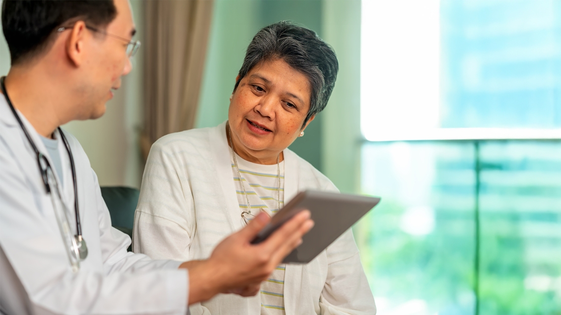 patient and doctor speaking in hospital room