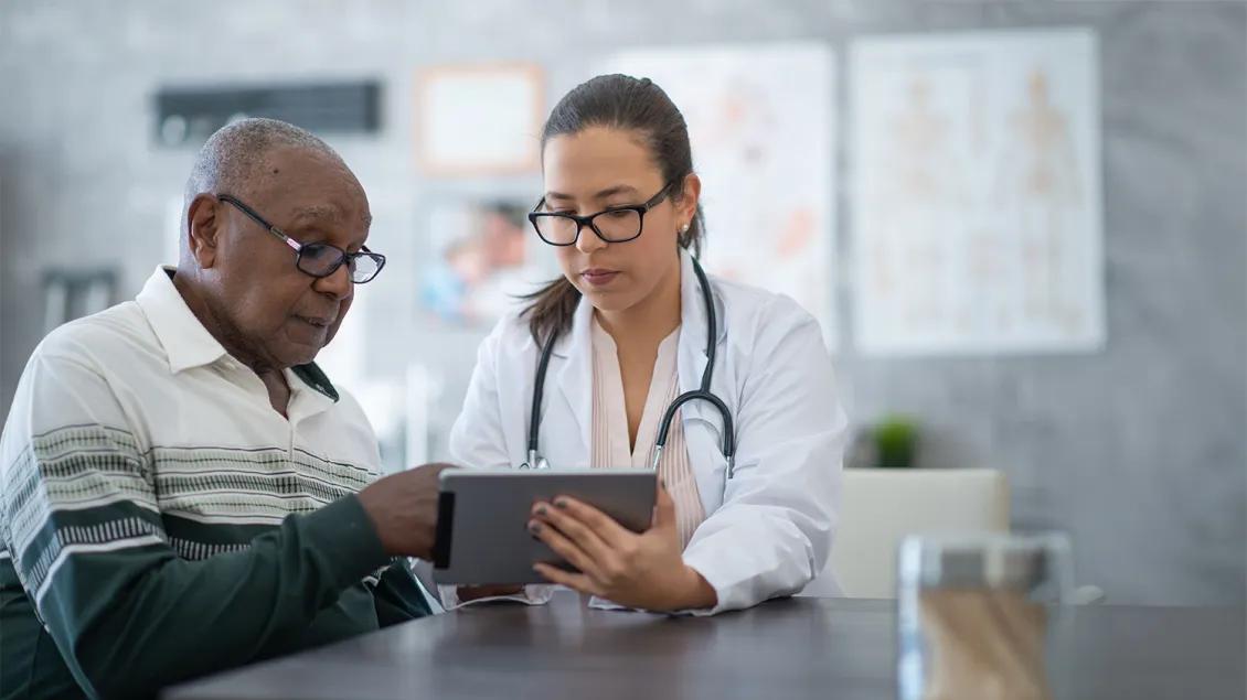 patient and doctor talking hospital room