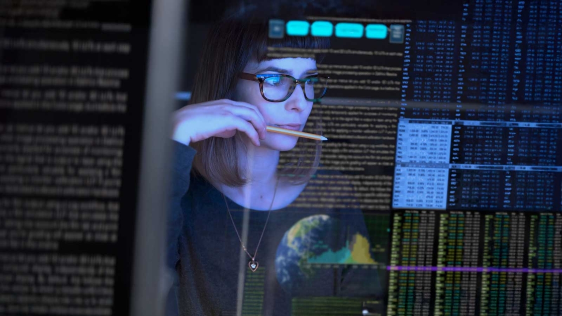Female researcher with pencil reviewing research