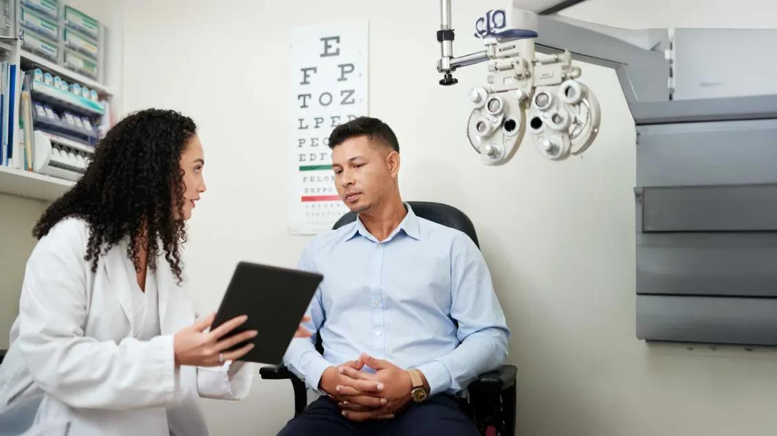 Researcher in Ophthalmology Explaining Findings to Patient