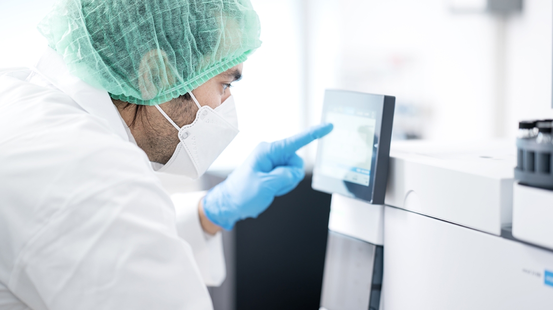 man in full PPE working in research lab