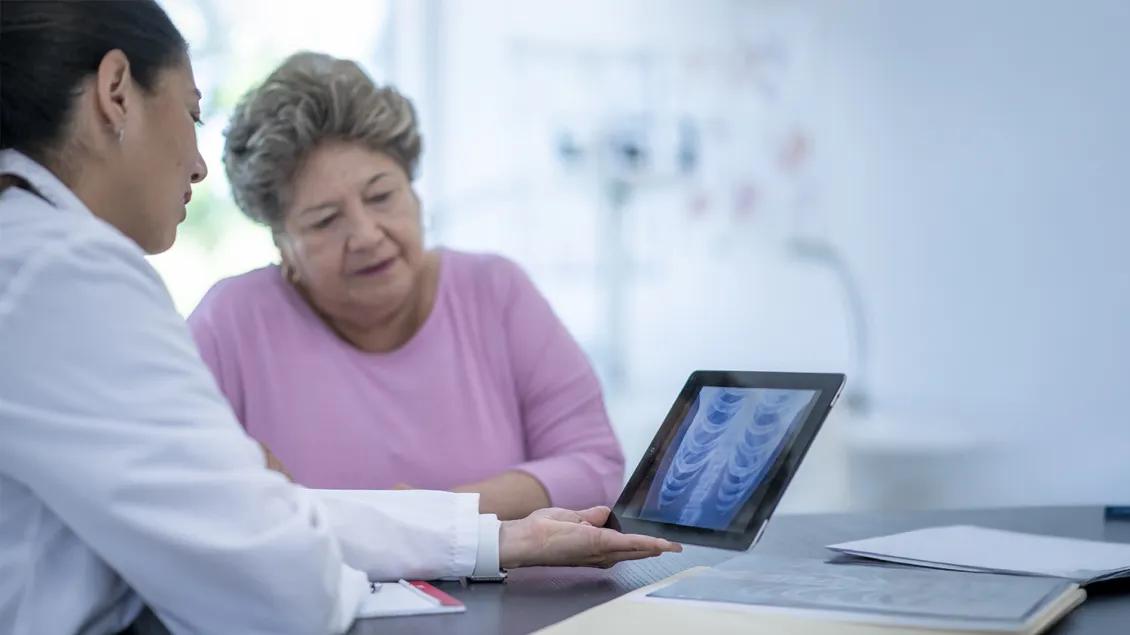 patient talking with doctor and looking at x-ray