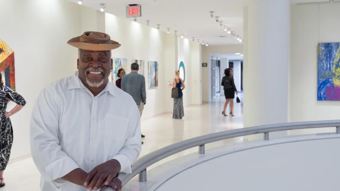 man posing for photo at art exhibition