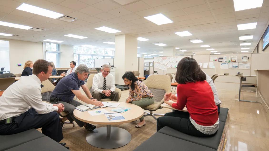 people talking around a table in lounge
