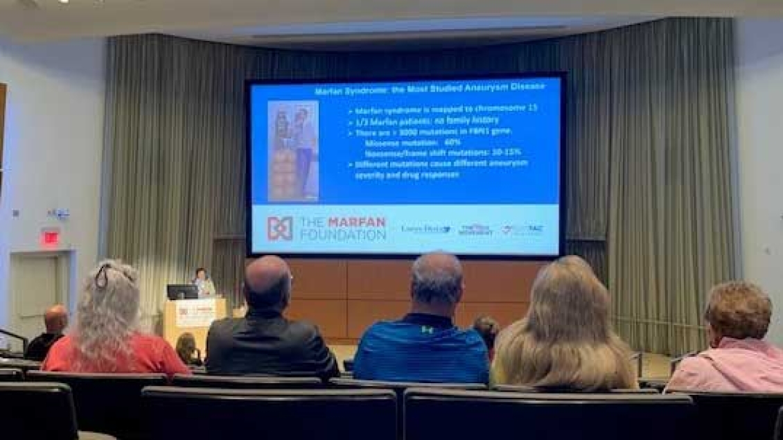 Public in auditorium listening to lecture on Marfan Disease