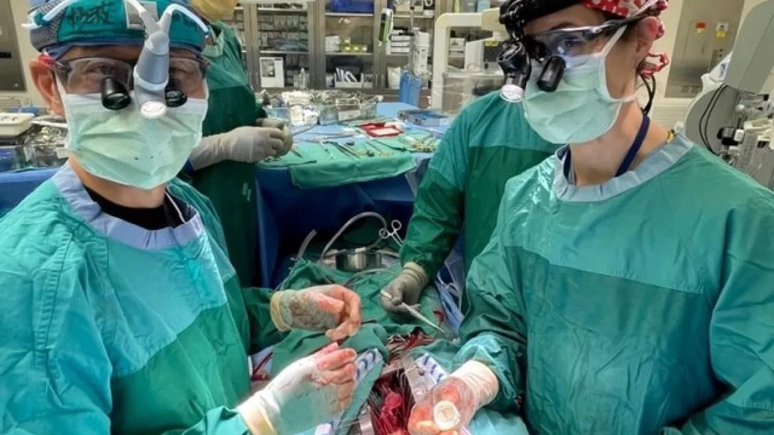 Two surgeons perform surgery in the operating room