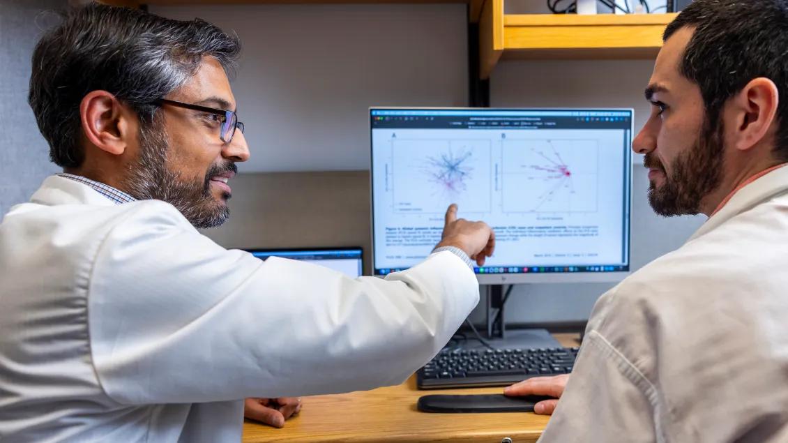 dr. rao and researcher looking at computer
