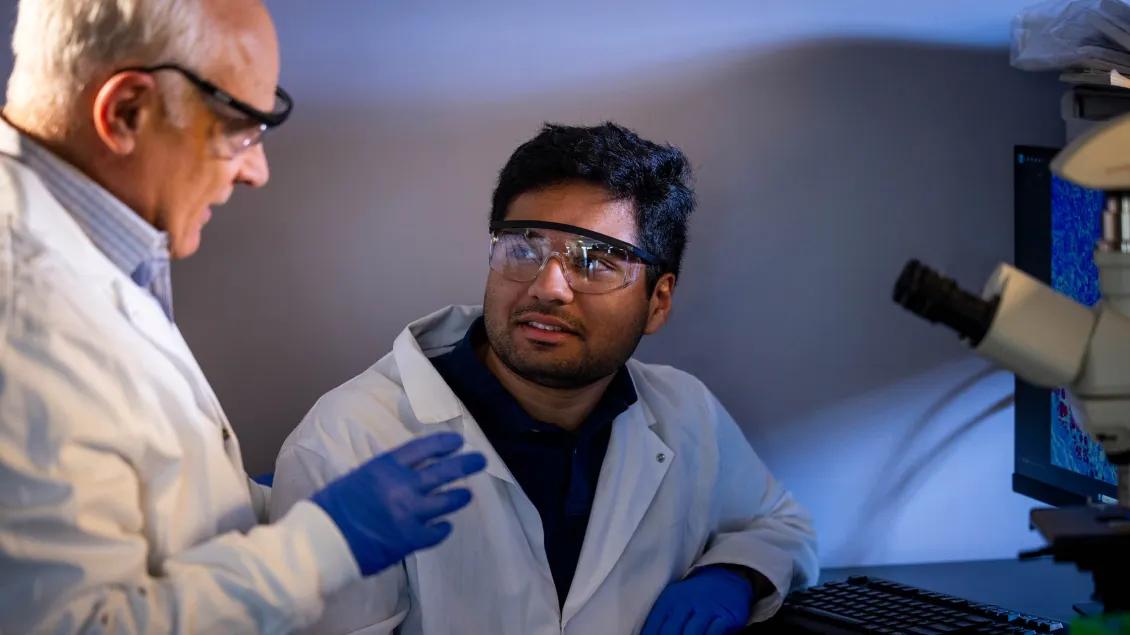 Dr. Varga with student in the lab