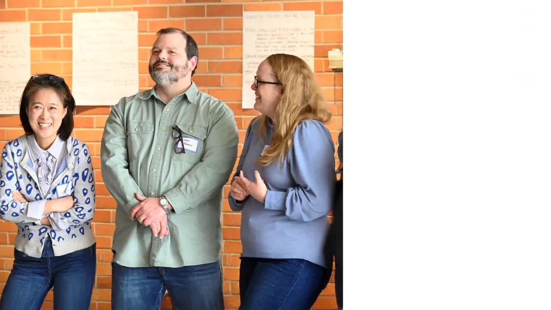 group of 3 people smiling