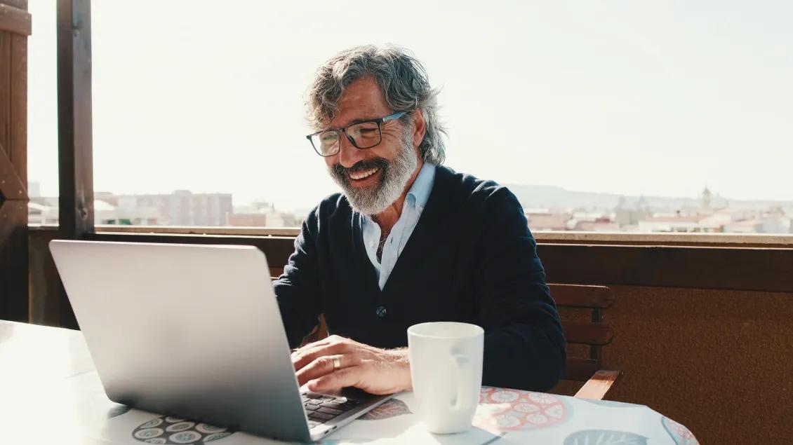 CODA Man Smiling At Computer