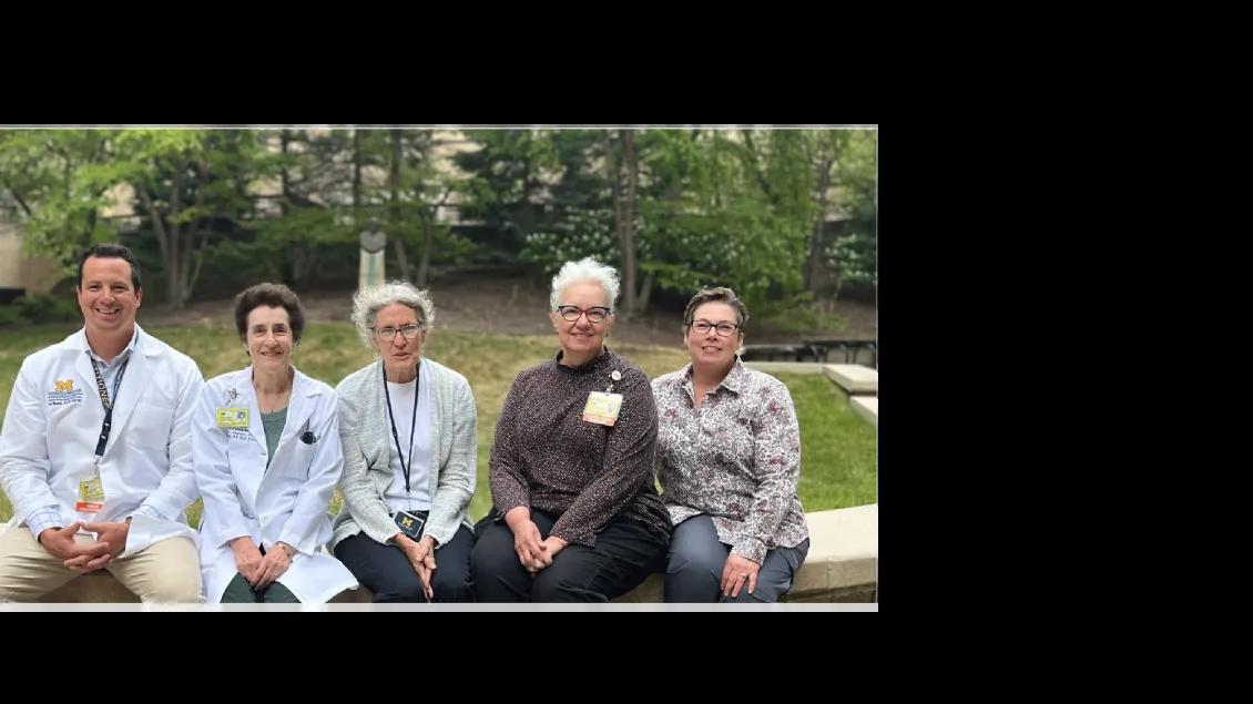 Members of the PCORI team sitting together outside in a row.