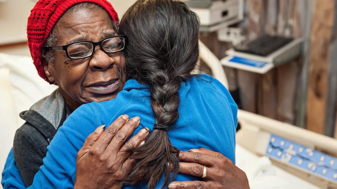 Close up of a women hugging patient