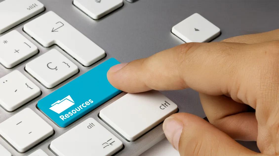 close-up of a person's hand clicking a keyboard
