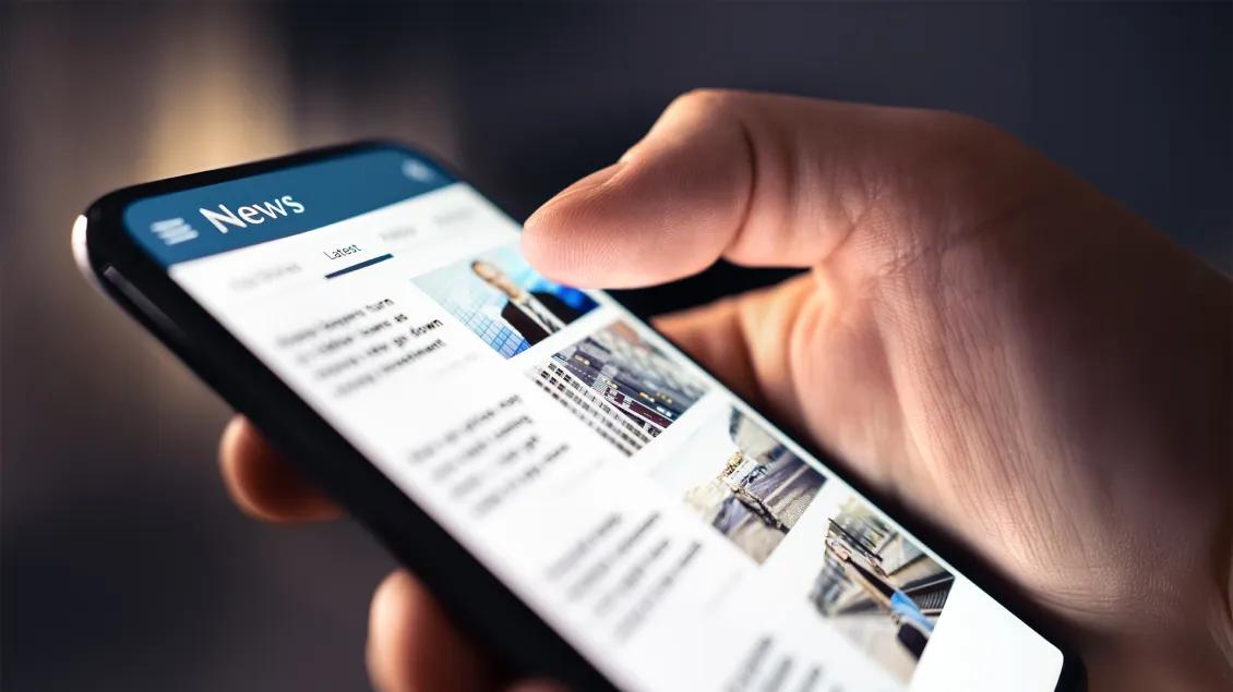close-up of phone screen with news feed